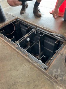 Automotive Rotary Lift Pit Shown Open, With Visible Corrosion
